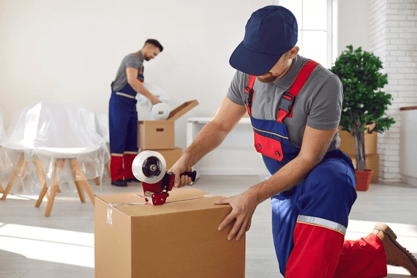 Professional home moving team handling packed boxes and personal belongings