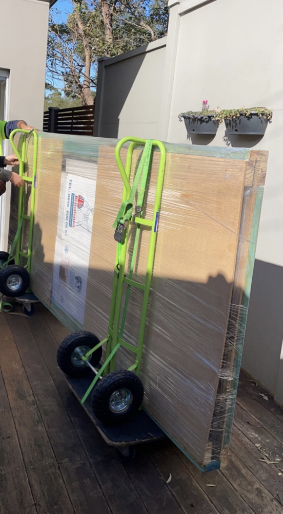 Removalist team arranging household items inside a moving truck
