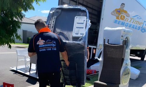 Professional furniture movers handling bulky household belongings