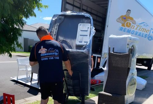 Professional furniture movers handling bulky household belongings
