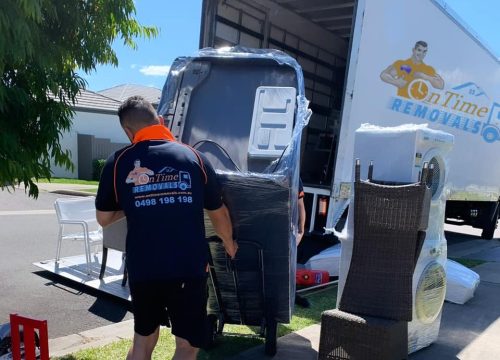Professional furniture movers handling bulky household belongings
