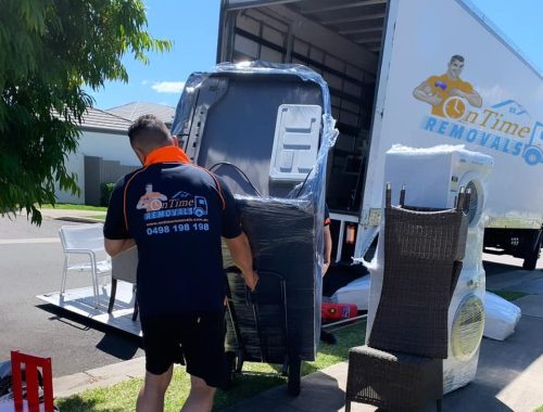 Professional furniture movers handling bulky household belongings