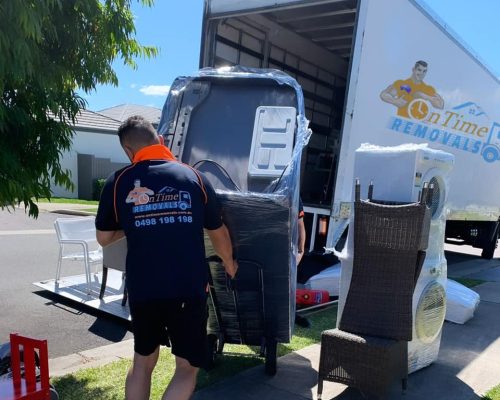 Professional furniture movers handling bulky household belongings