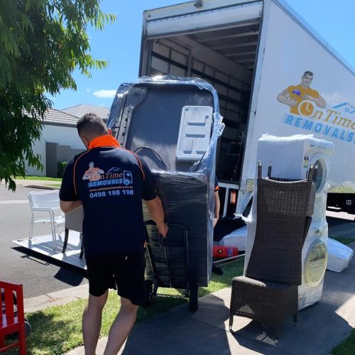 Professional furniture movers handling bulky household belongings