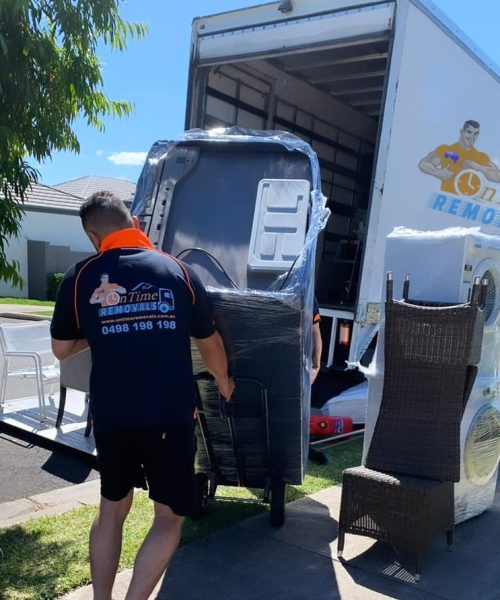 Professional furniture movers handling bulky household belongings