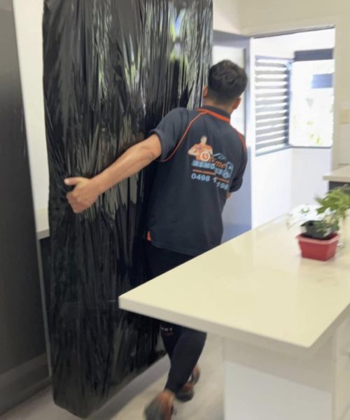 House removalists in Sydney moving furniture into a new family home