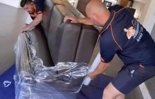 Furniture removal experts protecting sofas and tables during a move
