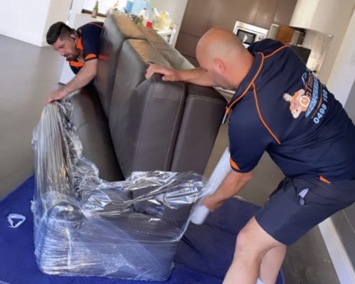 Furniture removal experts protecting sofas and tables during a move