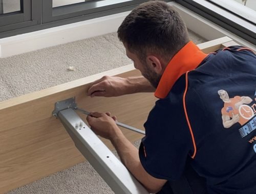 Professional moving team preparing furniture for secure transportation
