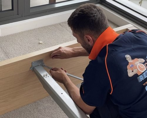 Professional moving team preparing furniture for secure transportation
