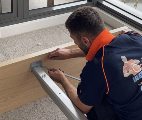 Professional moving team preparing furniture for secure transportation
