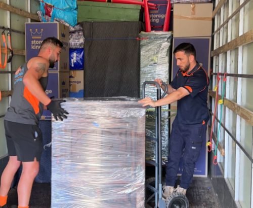 Removalist team organising packed cartons for efficient transportation