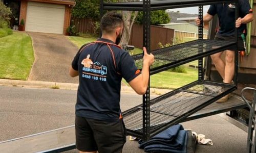 Professional movers unloading furniture at a new family house