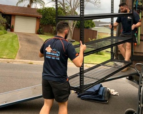Professional movers unloading furniture at a new family house