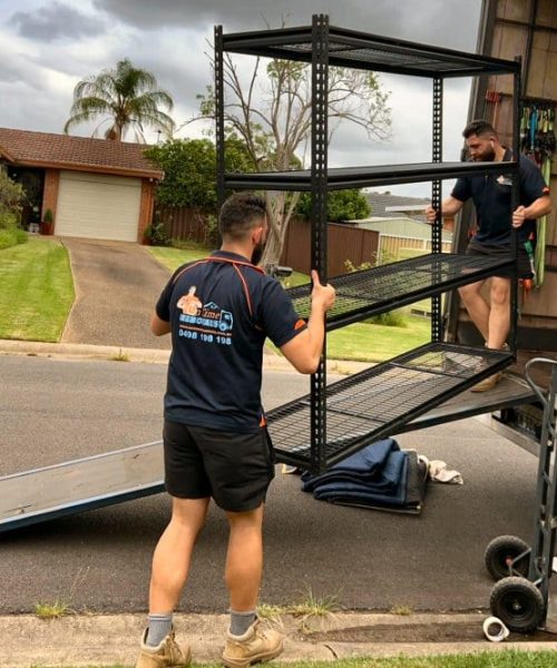 Professional movers unloading furniture at a new family house