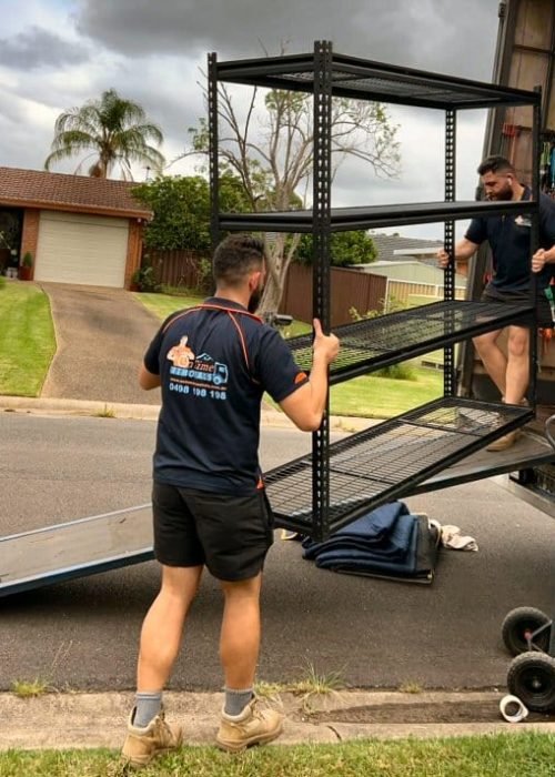 Professional movers unloading furniture at a new family house