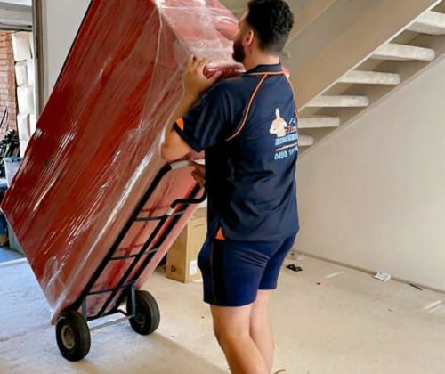 Professional home moving team handling packed boxes and personal belongings.