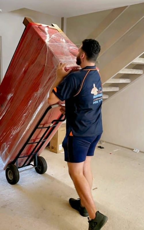 Professional home moving team handling packed boxes and personal belongings.