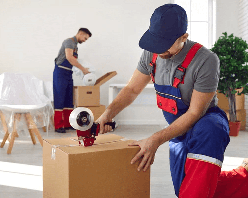 Professional home moving team handling packed boxes and personal belongings