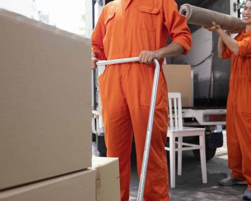 Business relocation team loading commercial furniture onto a moving truck